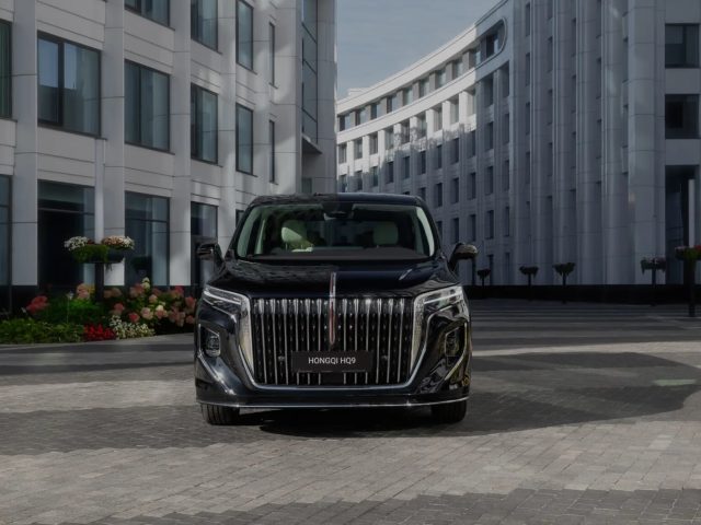 HONGQI E-HS9 у современного здания, фронтальный вид